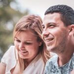 Happy couple enjoying a sunny day outdoors, captured in a candid moment of togetherness and joy.